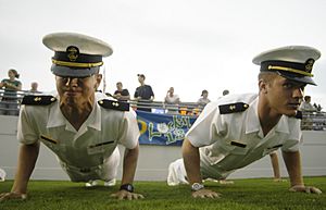 US Navy 030830-N-9693M-006 U.S. Naval Academy Midshipmen (Mid'n) do push-ups following a touchdown during Navy's football season opener against Virginia Military Institute (VMI)