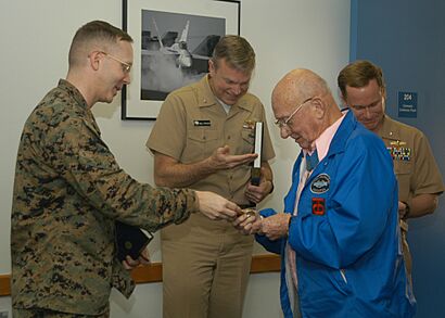 US Navy 070111-N-2789G-003 Lt. Col. James Dillon, commanding officer, Marine Corps Security Force Company (MCSFCo) Bangor, gives Bud Hawk, WWII Medal of Honor recipient, a MCSFCo Bangor command coin at Naval Base Kitsap Bangor
