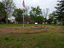 Flag, Flower Boxes, and Sign at The Old Presbyterian Graveyard