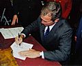 George W. Bush in Concord, New Hampshire signing papers for presidential run