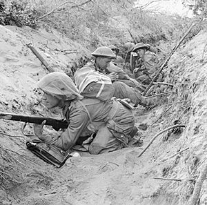 Men of 'D' Company, 1st Battalion, The Green Howards occupy a captured German communications trench during the offensive at Anzio, Italy, 22 May 1944. NA15297