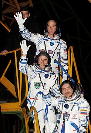 Expedition 13 Crew Members wave goodbye at launch pad.jpg