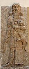 Possible representation of Gilgamesh as Master of Animals, grasping a lion in his left arm and snake in his right hand, in an Assyrian palace relief, from Dur-Sharrukin, now held in the Louvre