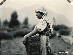 Native American women with basket of huckleberries (3230032308)