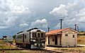 RM 1901 waits under looming skies at Texas station, Queensland, ~1991