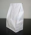 White paper bag on white and black background