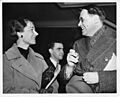Frederica Annis Lopez de Leo de Laguna (1906-2004), standing and talking at meeting with Kaj Birket-Smith (1893-1977)