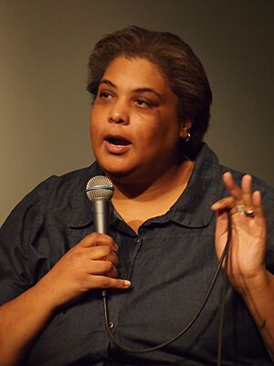 Gay speaking into a microphone