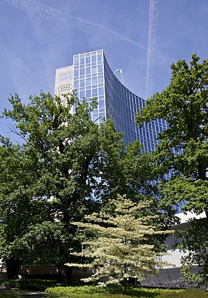 A tall modern building with trees in the foreground