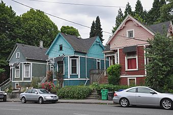 Photograph of three detached houses in a row along a street