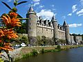 Fr Josselin Castle from river with flowers