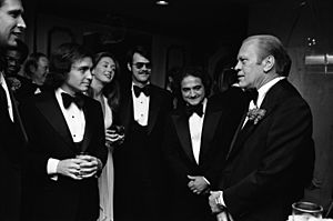 President Gerald R. Ford Talking with Chevy Chase, Saturday Night Live Producer Lorne Michaels, John Belushi, Dan Aykroyd, and Others at the 32nd Annual Radio and Television Correspondents Association Dinner - NARA - 30805929