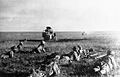 Japanese soldiers creeping in front of wrecked Soviet tanks