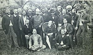 A portrait of twenty men (five seated in front) on a lawn