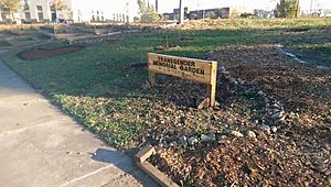 Sign with view of path and plantings, Transgender Memorial Garden