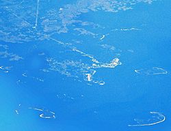 Aerial view of Cedar Key and its outlying islands, illustrating the extremely small size of the city:  The fork at State Roads 24 and 347 (the only two access roads) can be seen in the upper left.