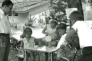 Children selling lemonade to an adult in La Canada, California, 1960