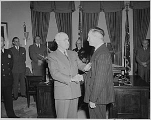 President Truman presents a Medal of Merit to Secretary of Defense James Forrestal in the Oval Office. - NARA - 199640