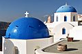 Reknown blue domes of the Church dedicated to St. Spirou in Firostefani, Santorini island (Thira), Greece