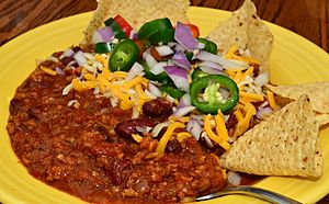 Chili with garnishes and tortilla chips