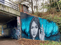 Graffiti - woman's face on blue background - Parkland Walk, London