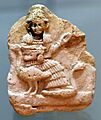 Terracotta plaque showing seated goddess Nanshe and geese. from southern Iraq. 2003-1595 BCE. Iraq Museum