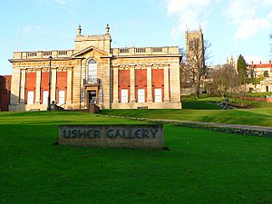 Front of the gallery, with a lawn and a sign