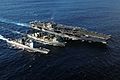 US Navy 050614-N-0120R-050 The conventionally powered aircraft carrier USS Kitty Hawk (CV 63) and the guided missile cruiser USS Cowpens (CG 63) receives fuel during a replenishment at sea