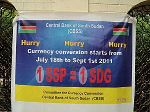 Banner in Juba mid July 2011 announcing the conversion from the Sudanese Pound (SDG) to the new currency the South Sudanese Pound (SSP)