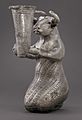 Proto-Elamite kneeling bull holding a spouted vessel