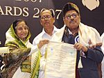 The President, Smt. Pratibha Devisingh Patil presenting the Dada Saheb Phalke Award for the year 2007 to the Playback Singer, Shri Manna Dey, at the 55th National Film Awards function, in New Delhi on October 21, 2009 (cropped).jpg
