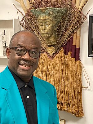 Gadson with his mixed media work Nubian Queen.jpg