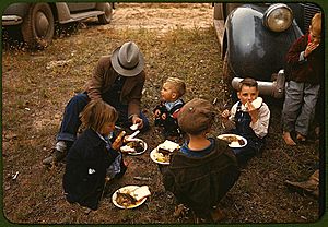 Homesteader and his children eating barbeque at the New Mexico Fair. Pie Town, New Mexico, October 1940