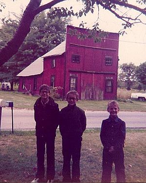 Author Lorin Morgan-Richards (on right) as a child with his brothers in Beebetown, Ohio. The old blacksmith shop (no longer standing) is seen in the background.