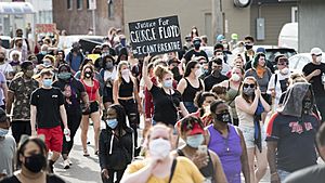 Protesters marching in Minneapolis on May 26, 2020, the day after Floyd's murder. A protester's sign reads, "Justice for George Floyd" and "#I CANT BREATHE".