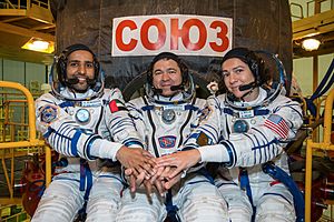 Soyuz MS-15 crew members in front of their spacecraft