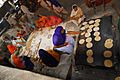 Women preparing roti for visitors of Harmandir Sahib