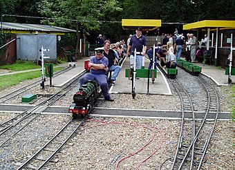 miniature trains, volunteers and visitors at the railway's station