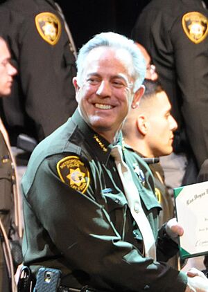 Jonathan Carrington receives certificate from Joseph Lombardo (cropped)