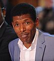Olympic great Haile Gebrselassie speaking at the Olympic hunger summit in Downing Street, 12 August 2012 (cropped)