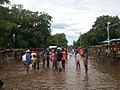 People stand in a flooded street that usually serves as a farmers market, in Ouanaminthe, northeast Haiti, Sept. 8, 2017. (Photo - Josiah Cherenfant, courtesy VOA Creole Service)