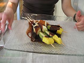 Fruits brochette with warm chocolate