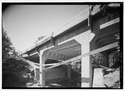 PERSPECTIVE ELEVATION LOOKING SOUTHEAST AT CHENOWETH CREEK BRIDGE. INSULATED POWERLINE STRUNG ACROSS FRONT. - Historic Columbia River Highway, Troutdale, Multnomah County, OR HAER ORE,26-TROUT.V,1-112.tif