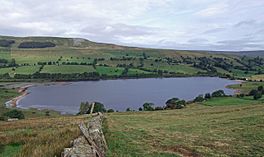 Image of an upland lake surrounded by fields and limestone hills