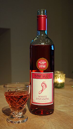 Bottle and glass of Barefoot white zinfandel wine, 2012