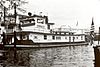 Black-and-white photo of long towboat on the water