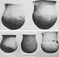 A black and white picture of several large ceramic vessels