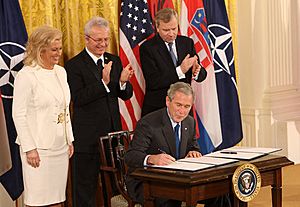 President George W. Bush signs the NATO accession protocols in the East Room of the White House