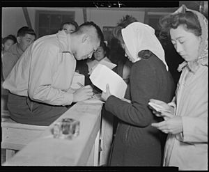Tule Lake Relocation Center, Newell, California. Absentee voters of Japanese descent getting ballot . . . - NARA - 536513