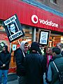 Protestors outside Vodafone shop.